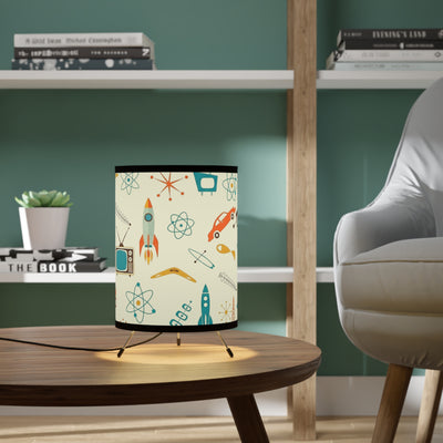 Table lamp with retro design on a wooden table in a room with shelves and a chair.