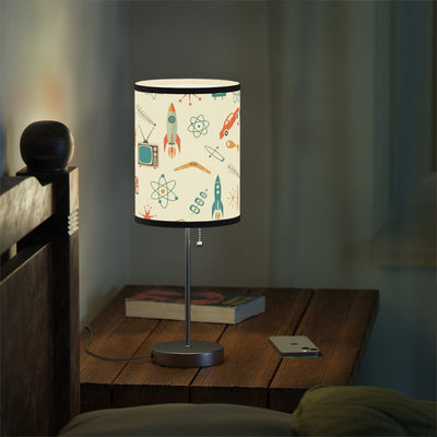 Table lamp with a colorful design on a wooden nightstand in a dimly lit room.