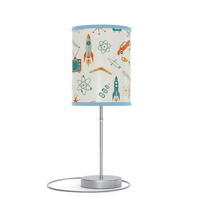 Table lamp with a colorful lampshade featuring space-themed designs on a white background.