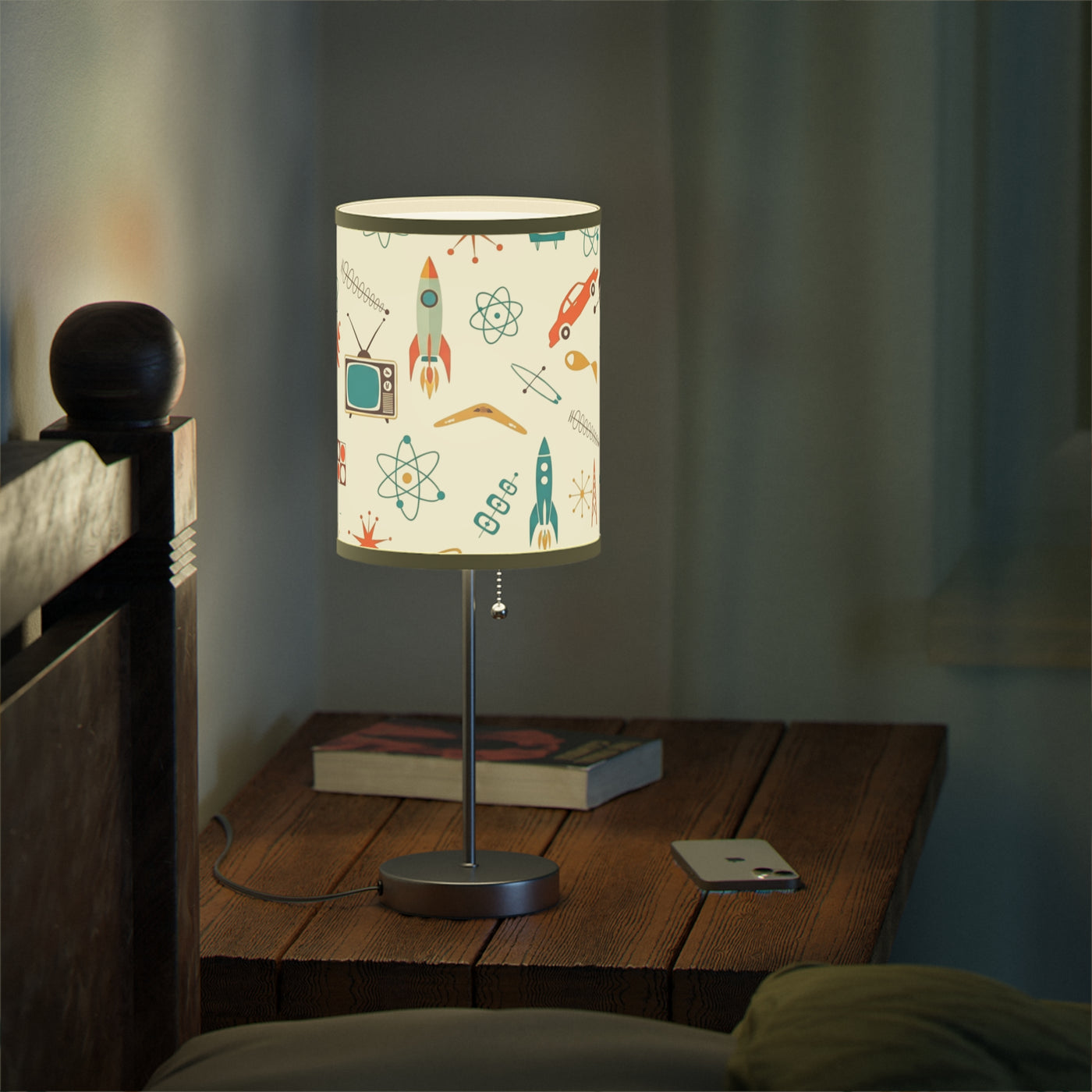 Table lamp with a colorful design on a wooden nightstand in a dimly lit room.