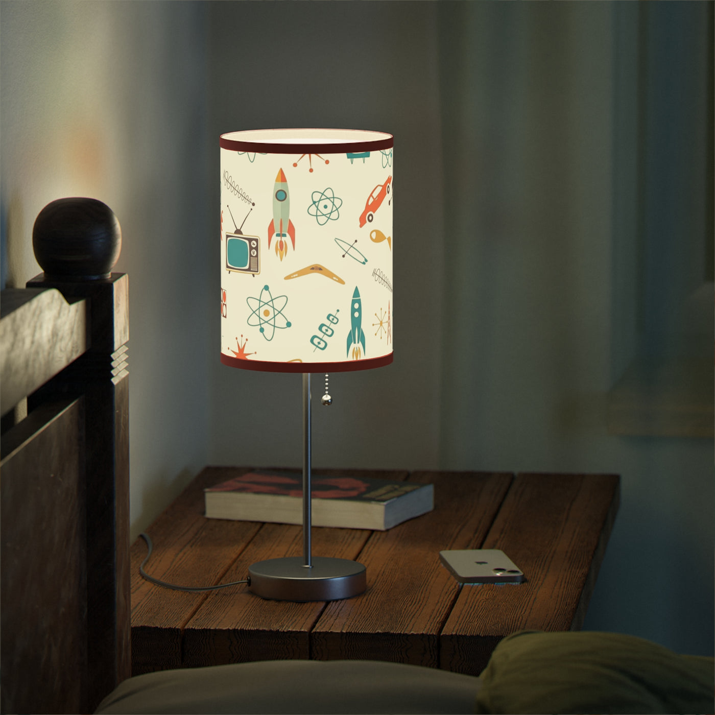 Table lamp with a colorful design on a wooden nightstand in a dimly lit room.