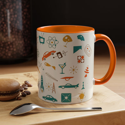 Mug with colorful patterns on a wooden surface with coffee beans and a spoon.