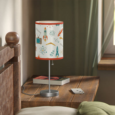 Table lamp with a colorful design on a wooden nightstand in a bedroom setting.