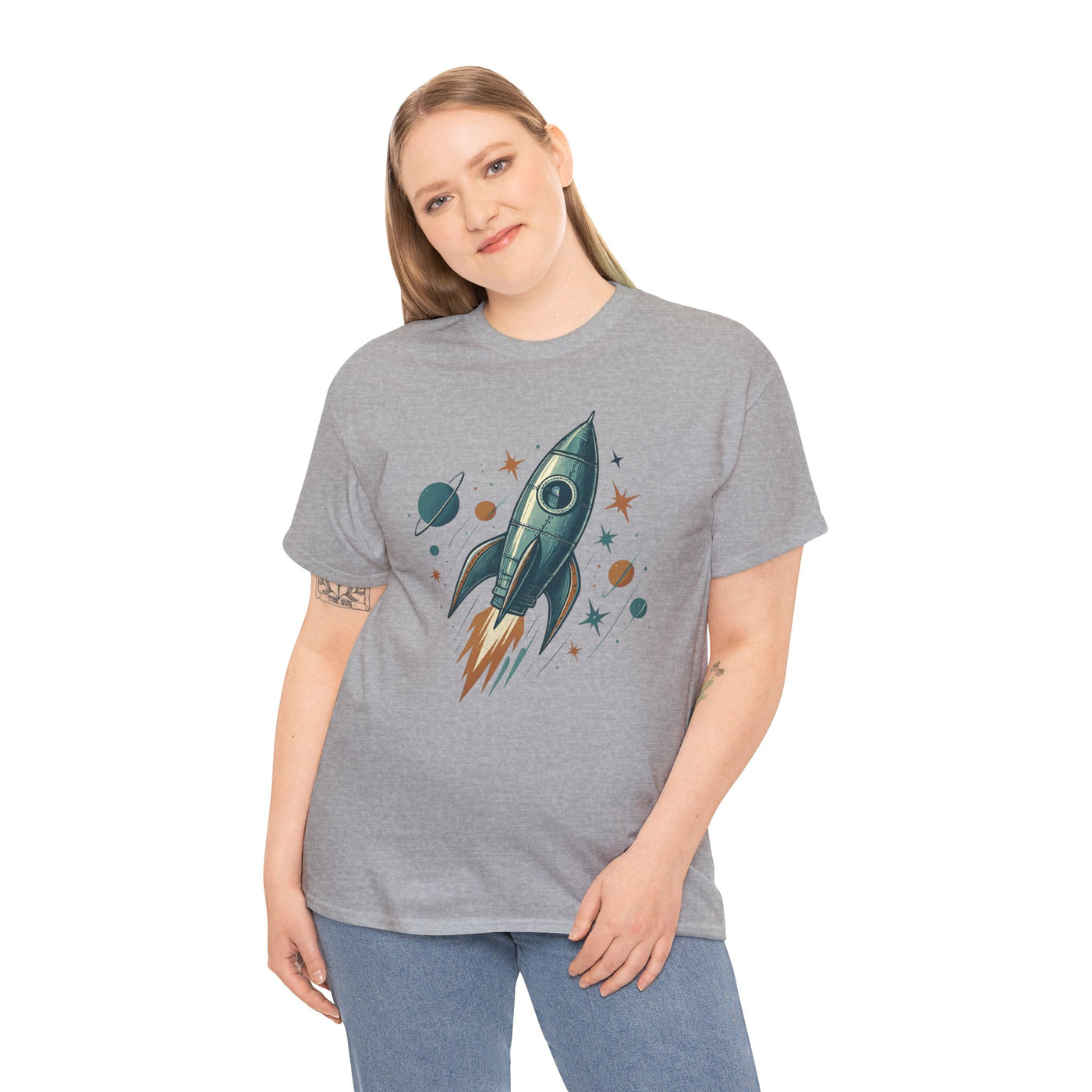 Person wearing a gray t-shirt with a rocket ship design on a white background